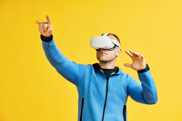 Man wearing virtual reality goggles over yellow background