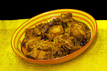 Slow cooked shredded pulled beef in colorful ceramic plate