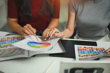 Fototapeta premium Graphic designer with colleague brainstorming on table
