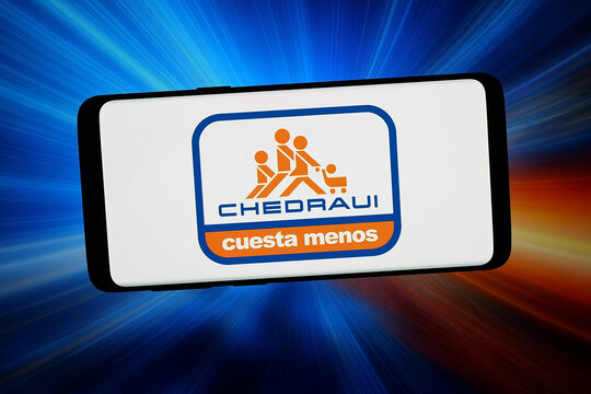 Stuttgart, Germany - 02-20-2026: In this photo illustration, the logo of Mexican company Grupo Comercial Chedraui is displayed on a smartphone in front of abstract background on computer screen.