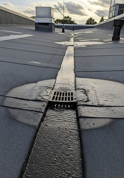 Efficient water drainage system installed on flat industrial rooftop surface