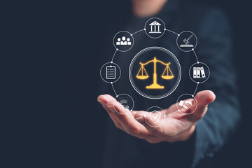 Hand presenting glowing scales of justice with legal service icons, law and compliance concept for corporate governance, contract management, protection and regulatory advisory.