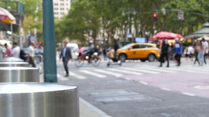 Sixth 6 avenue and 42nd street crossroad, Bryant park in Manhattan Midtown, New York City, United States of America. Defocused people pedestrians crossing on zebra near bank, yellow taxi car on road. © Dogora Sun