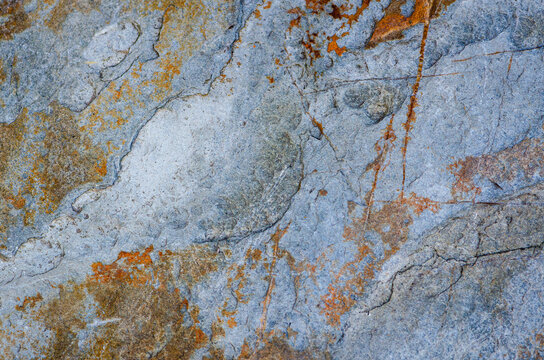 blue shaded rock surface textured abstract, ochre and orange patterns