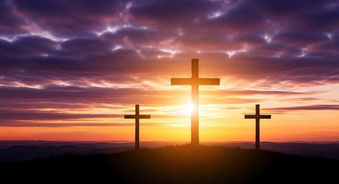 Three wooden crosses silhouetted on a hill at dramatic sunset.