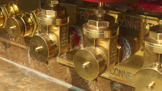 Industrial pipe fittings, focusing on detailed view of brass couplings and gasket surfaces, clutter of metal pipe attachments emphasizing rugged texture and frequent handling in industrial plumbing
