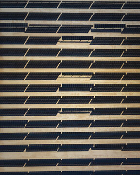 Aerial view of rhythmic patterns of light and shadow dance across the structured facade, creating an abstract urban tapestry, El Centro, California, United States.