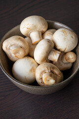Close-up of a bunch of fresh white button mushrooms, showcasing natural texture and freshness