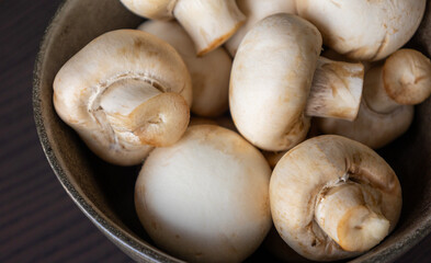 Close-up of a bunch of fresh white button mushrooms, showcasing natural texture and freshness