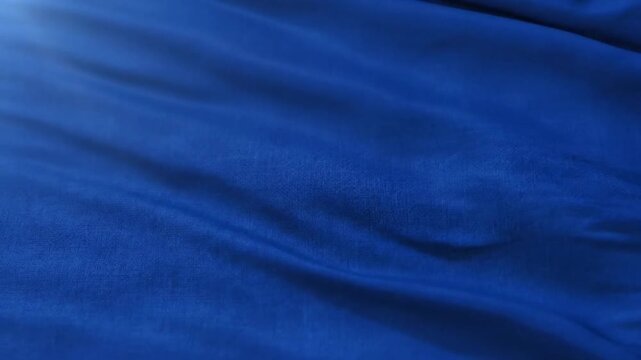 Closeup of Smooth Blue Fabric with Gentle Waves in Natural Light