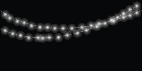 Glowing white string lights illuminate a dark celebration background creating a festive and magical atmosphere