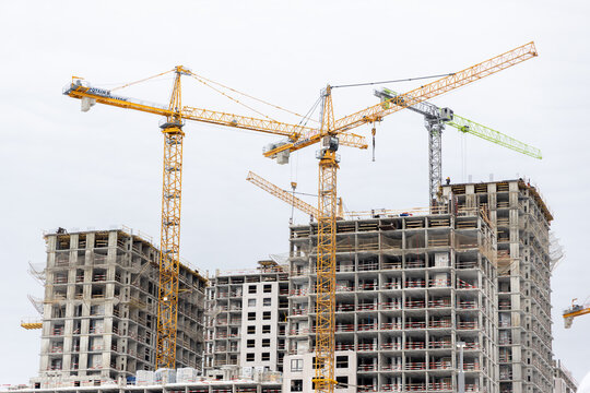 Russia. Moscow. Izmailovo. February 22, 2026 Multi-story residential buildings under construction with Liebherr and Potain tower cranes
