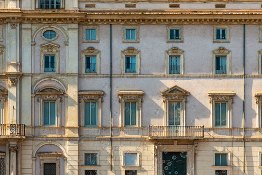Sant Agnese in Agone baroque church building facade with classical architectural details, windows and balconies in Piazza Navona with floating soap bubbles, Rome city, Italy. Italian architecture