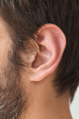 Close up of adult man ear and sideburn with natural skin texture and beard detail, anatomy, hearing and personal healthcare concept
