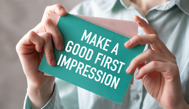 Person holding card with Make a Good First Impression text