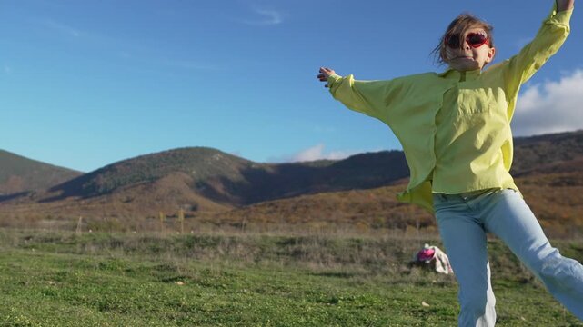 Girl, Dancing, Mountains, doing splits and enjoying freedom outside against beautiful autumn landscape and blue sky.