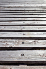 Obraz premium Vertical view of horizontal wooden planks with screws showing texture and grain. wood background, natural material, rustic surface.