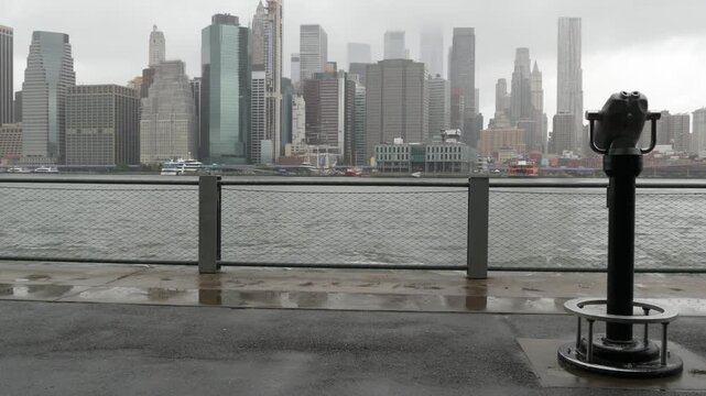 Manhattan downtown skyline from Brooklyn Bridge Park, New York City, United States. Financial district skyscrapers buildings. American architecture of business center. Tower viewer binocular telescope