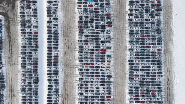 Aerial view of dense rows of cars creating a patterned landscape amidst the stark white snow, a mosaic of color and form, Fall River, Massachusetts, United States.