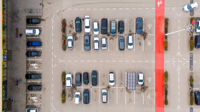 Aerial view of neatly arranged cars in a parking lot with red pedestrian lanes cutting through, Sremska Mitrovica, Vojvodina, Serbia.