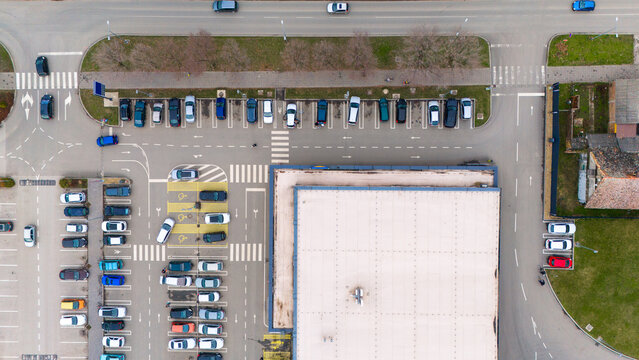 Aerial view of orderly parking lots and roads create a geometric tableau, a blend of concrete and asphalt, accentuated by parked cars, Sremska Mitrovica, Vojvodina, Serbia.