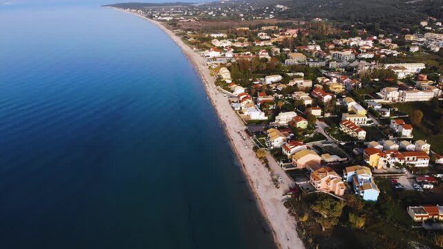 Aerial drone view of Acharavi beach, coast sea village settlement, Thinali, Agios Panteleimonas, North Corfu island, Ionian Islands, Kerkyra, Greece in a summer sunny day with villas, town, sandy beac