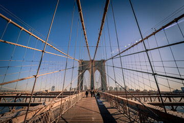 Fototapeta premium Breathtaking view of the famous Brooklyn Bridge crossing the East River in New York City, NY, USA, on a cold winter day looking towards Brooklyn