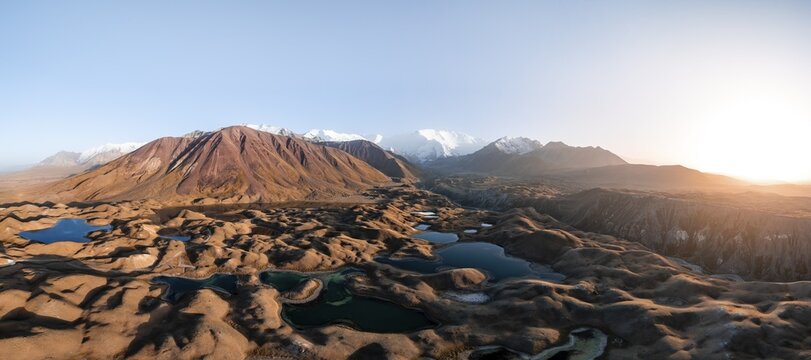 Atmospheric aerial view, high mountain landscape with glacier moraines and mountain lakes, behind Pik Lenin, Trans Alay Mountains, Pamir Mountains, Osher Province, Kyrgyzstan