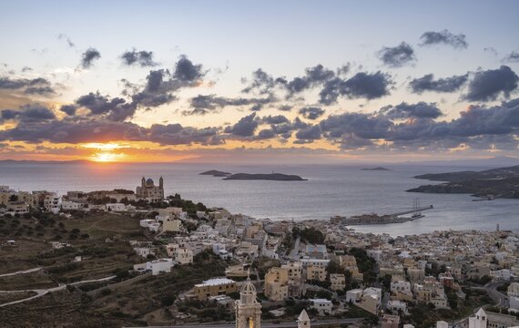 View from Ano Syros to the houses of Ermoupoli with the Anastasi Church or Church of the Resurrection, town view with islands and sea, dramatic cloudy sky at sunrise, Ano Syros, Syros, Cyclades, Greece
