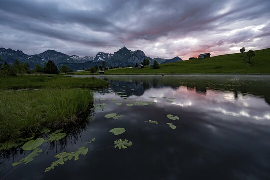 Schwendisee with reflection of the Altmann peak, Wildhaus, Appenzell, Switzerland