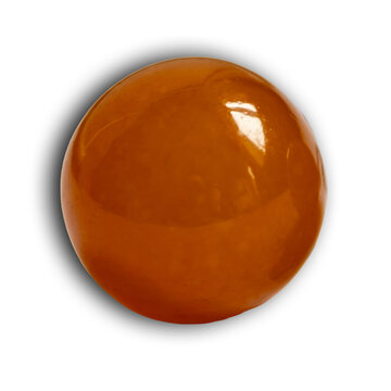 amber softgel capsule isolated on black background, macro close-up