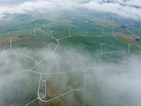 Windmills on a wind farm near Zahara de los Atunes, at a cloudy morning, aerial view, drone shot, C&aacute;diz province, Andalusia, Spain