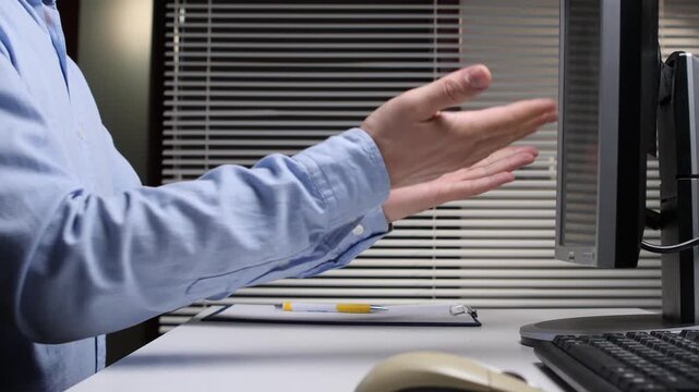 Man feeling intense anger and stress while shouting at a computer monitor in an office, experiencing technical problems, business pressure, and workplace frustration