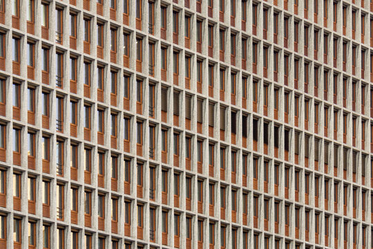Rhythmic Modernist Facade of a Public Building in Oslo Norway Featuring a Modular Concrete Grid and Wooden Window Frame Detail
