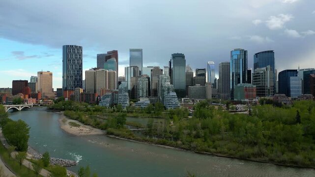 Calgary drone aerial view of skyline with modern skyscrapers lining the Bow River in Alberta, Canada