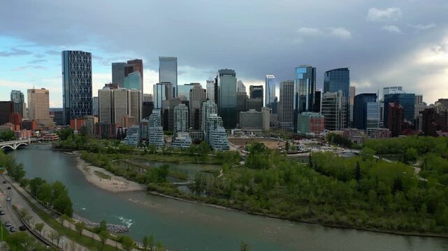 Calgary drone aerial view of skyline with modern skyscrapers lining the Bow River in Alberta, Canada
