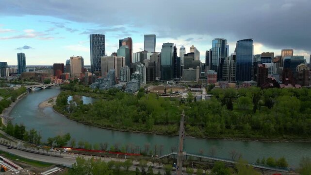 Calgary drone aerial view of skyline with modern skyscrapers lining the Bow River in Alberta, Canada