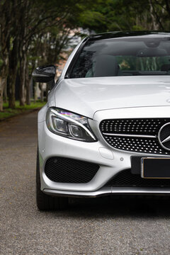 Silver Mercedes-AMG C43 front headlight and grille close up, Luxury performance car external detail