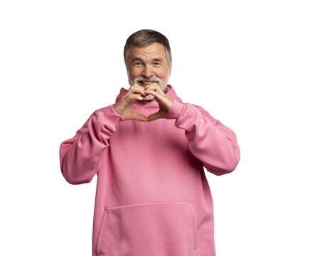Portrait of happy handsome mature man making heart with fingers on transparent