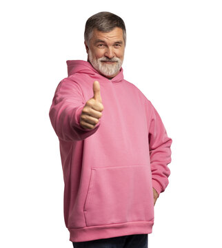 Attractive cheerful mature man wearing pink sweatshirt standing isolated over transparent background, showing thumbs up