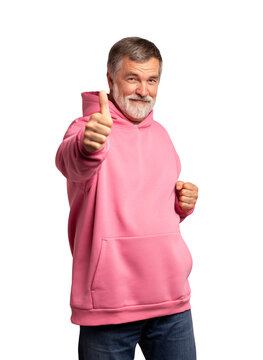 Attractive cheerful mature man wearing pink sweatshirt standing isolated over transparent background, showing thumbs up