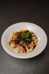 Naklejka premium Turkish manti with yogurt and spicy butter sauce on stainless steel counter