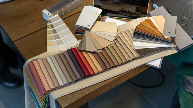 selection of fabric and color of curtains, textiles and furniture, beige satin. samples of fabrics for curtains in the curtain salon. exhibition samples, advertising, interior design, home comfort