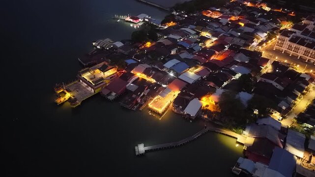 Night drone view of Pengkalan Weld tepi pantai stilt houses and jetties