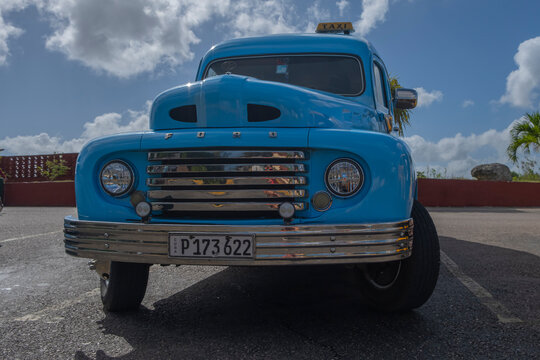 Old retro classic American car Ford truck from 1950s at a parking lot. Wide angle shot, sunny day, selective focus. Havana, Cuba.
