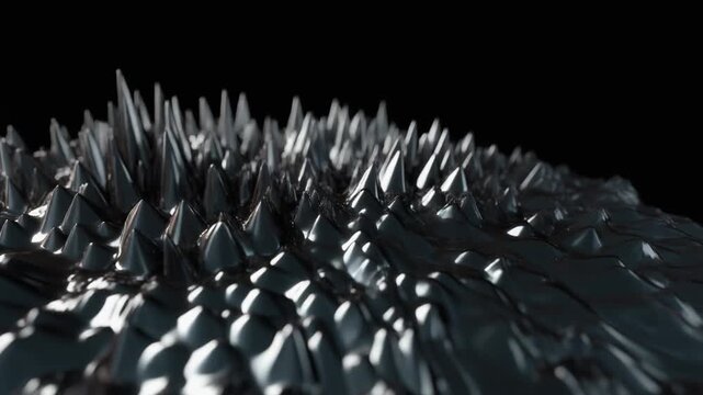 Close-up of sharp metal spikes on black background