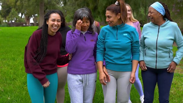 Happy group of multiracial women with different age and body walking together at city park - Multi generational people, sport training and female community concept