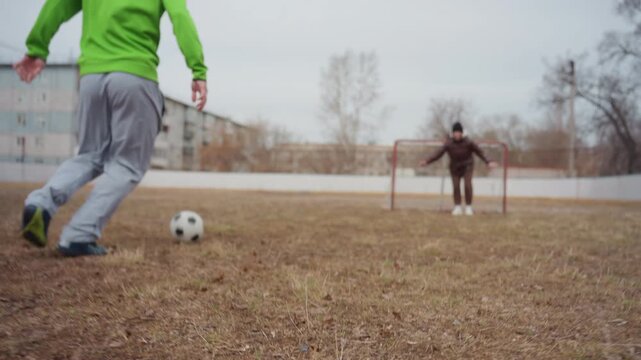 attacker rushes towards goalkeeper, fastpaced scene of offensive move, action shot of striker heading for goal, dynamic image capturing offensive player approaching goal during practice