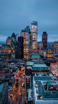 Aerial hyperlapse view of the City skyline of London, England, with street traffic and fast moving clouds