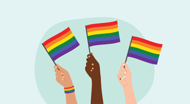 Three diverse hands are raised, proudly waving colorful rainbow flags to celebrate Pride Month and support the LGBTQ+ community.